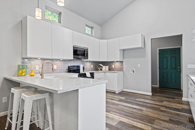 kitchen featuring sink, white cabinetry, black / electric stove, dark hardwood / wood-style flooring, and pendant lighting