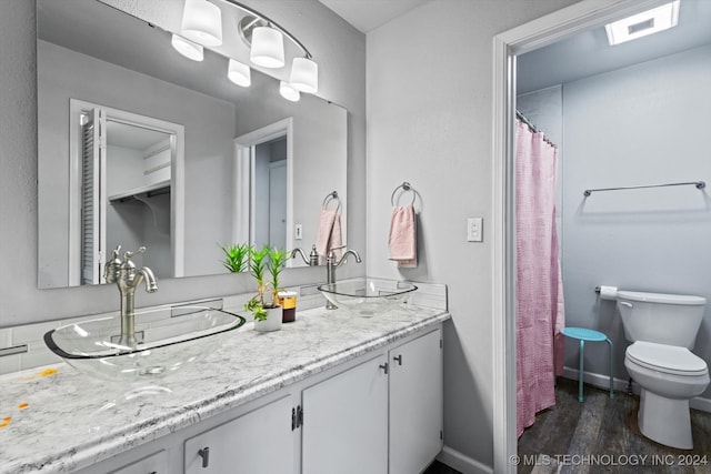 bathroom featuring hardwood / wood-style floors, vanity, and toilet