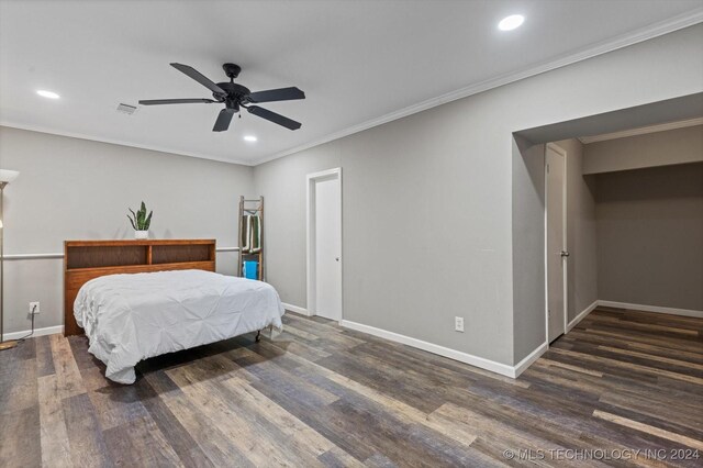 bedroom featuring ceiling fan, dark hardwood / wood-style flooring, and crown molding