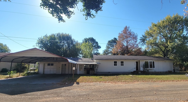 single story home featuring a front lawn and a carport