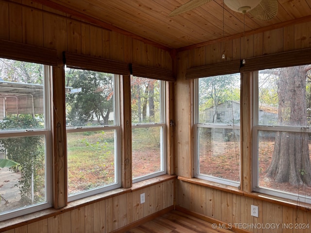 unfurnished sunroom with wood ceiling and a healthy amount of sunlight