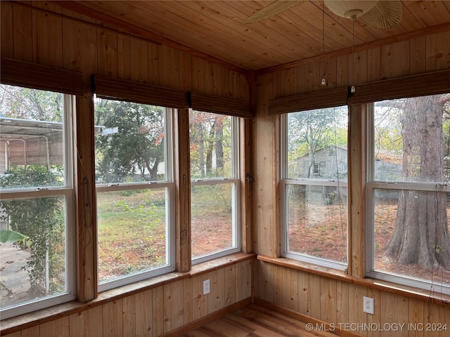 unfurnished sunroom featuring wood ceiling and a wealth of natural light