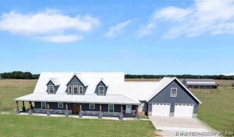 view of front of property with a garage, a front yard, and covered porch