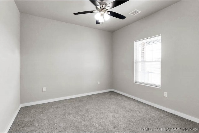 carpeted spare room featuring ceiling fan