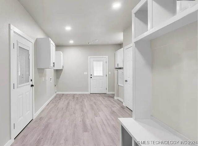 laundry room featuring light wood-type flooring