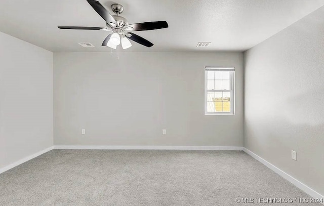 empty room featuring carpet flooring and ceiling fan