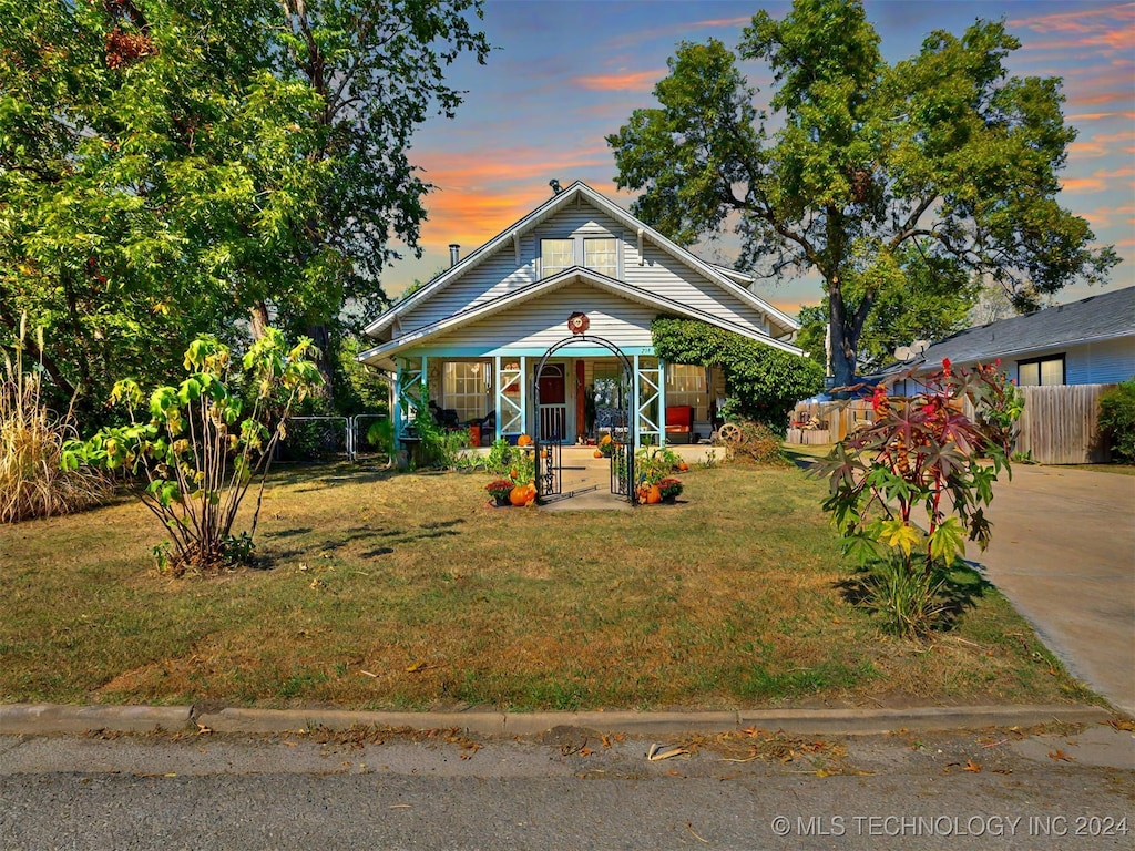 bungalow-style house featuring a yard and a porch