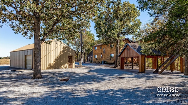 exterior space featuring an outbuilding, a garage, and a carport