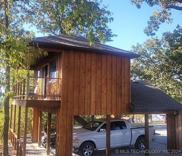 view of side of home with a carport