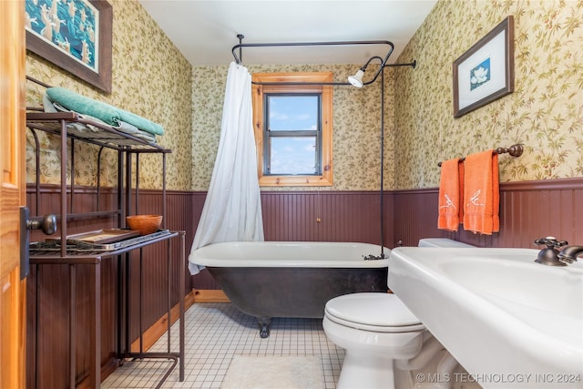 full bathroom with toilet, tile patterned floors, shower / bathtub combination with curtain, and sink