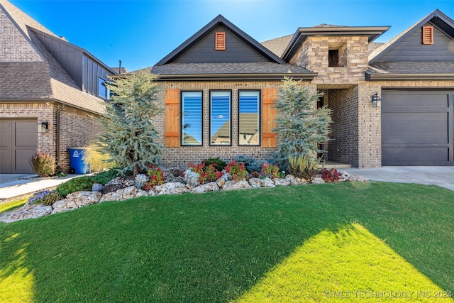 view of front facade with a front yard and a garage