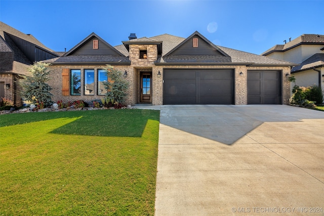 view of front of property with a front yard and a garage