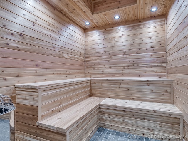 view of sauna featuring wood ceiling and wood walls