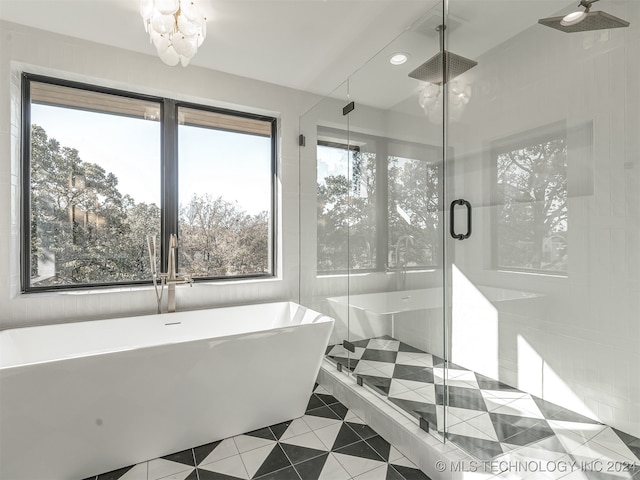 bathroom with separate shower and tub and tile patterned flooring