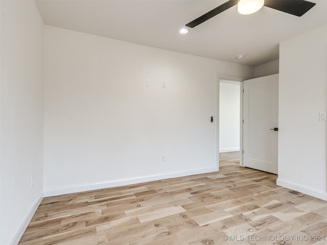 spare room featuring light hardwood / wood-style flooring and ceiling fan