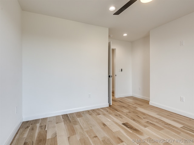 spare room with light hardwood / wood-style flooring and ceiling fan