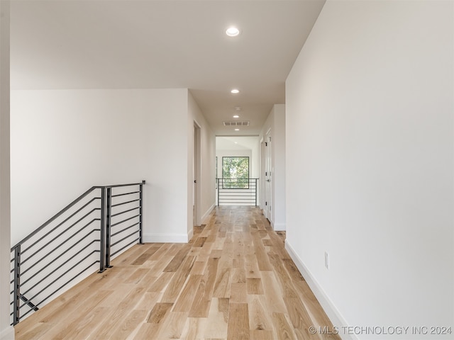 hallway with light hardwood / wood-style flooring