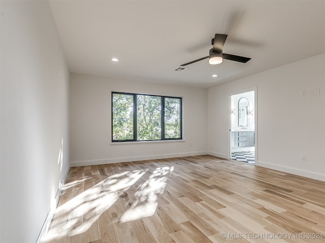 empty room featuring light wood-type flooring and ceiling fan