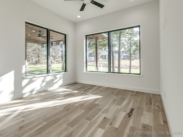 spare room featuring light hardwood / wood-style flooring and ceiling fan