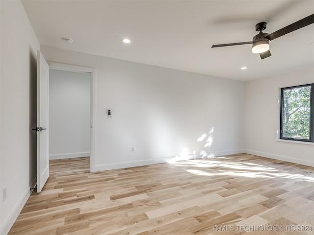 spare room featuring light hardwood / wood-style floors and ceiling fan