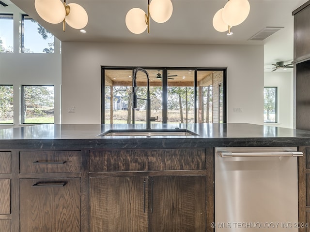 kitchen with stainless steel dishwasher, sink, dark brown cabinets, and ceiling fan