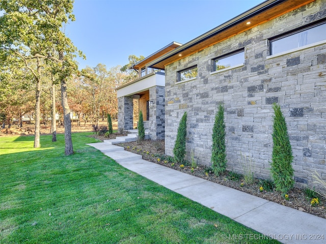 view of side of home featuring a lawn