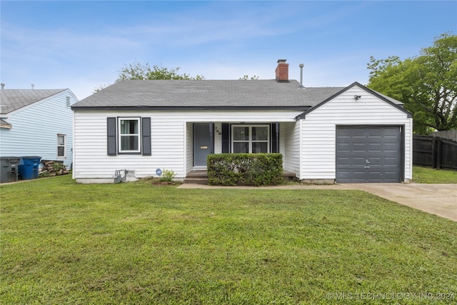 ranch-style home featuring a front lawn and a garage