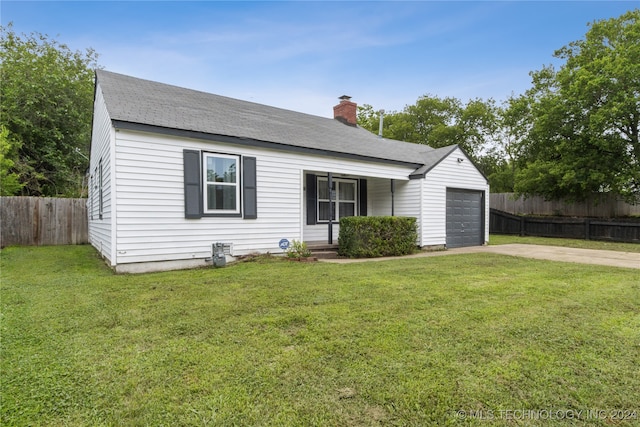 view of front of property with a front yard and a garage