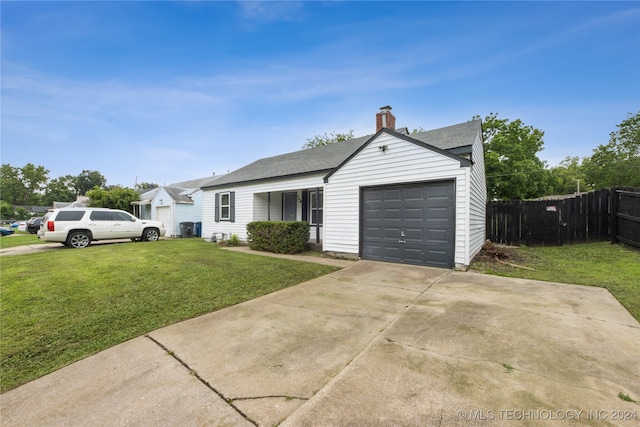 single story home featuring a garage and a front lawn