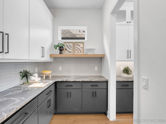 kitchen featuring white cabinetry, gray cabinetry, and backsplash