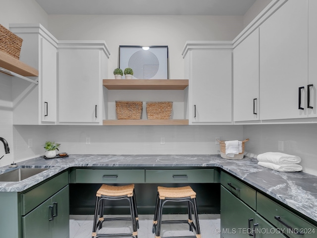 interior space featuring sink, white cabinets, and green cabinets