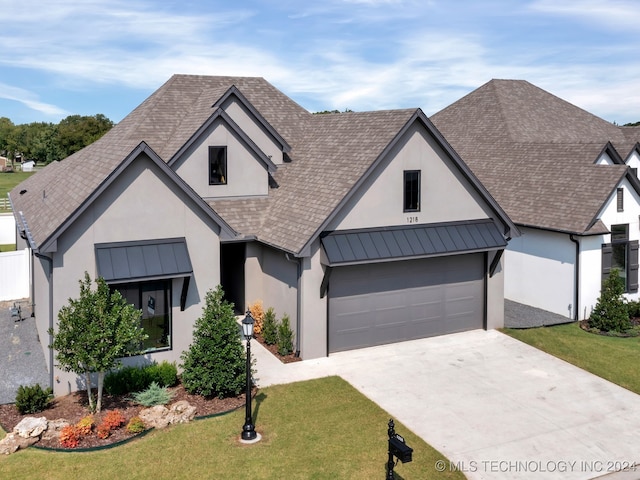 view of front of property featuring a front yard and a garage