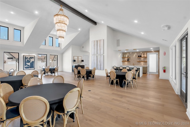 dining room featuring beam ceiling, light hardwood / wood-style flooring, and high vaulted ceiling