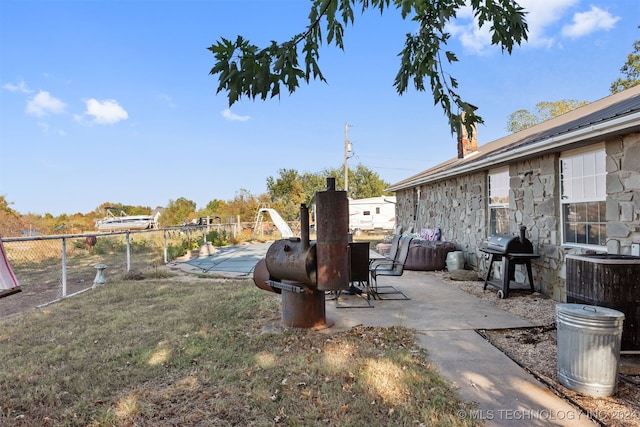 view of yard with cooling unit and a patio