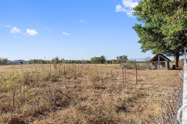 view of yard with a rural view