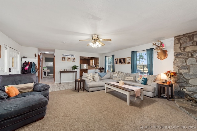 living room featuring hardwood / wood-style flooring and ceiling fan