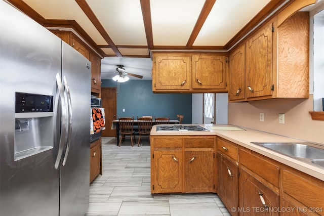 kitchen featuring white gas stovetop, stainless steel fridge, kitchen peninsula, and ceiling fan