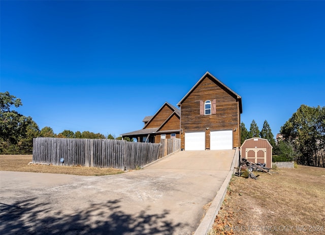 view of front of house with a shed and a garage