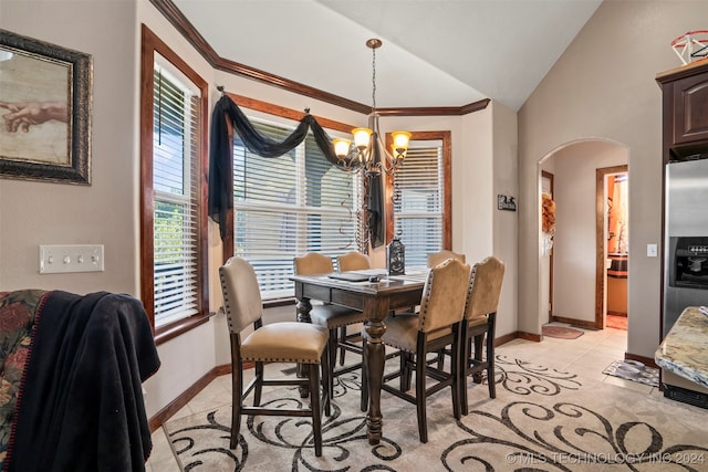 dining space featuring a notable chandelier, light tile patterned floors, crown molding, and vaulted ceiling