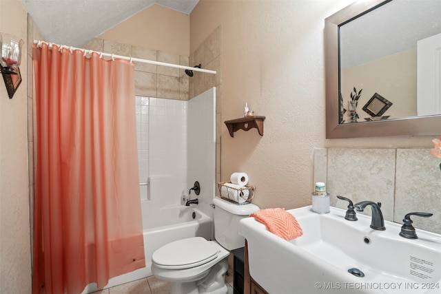 full bathroom with shower / tub combo, a textured ceiling, toilet, vanity, and tile patterned flooring