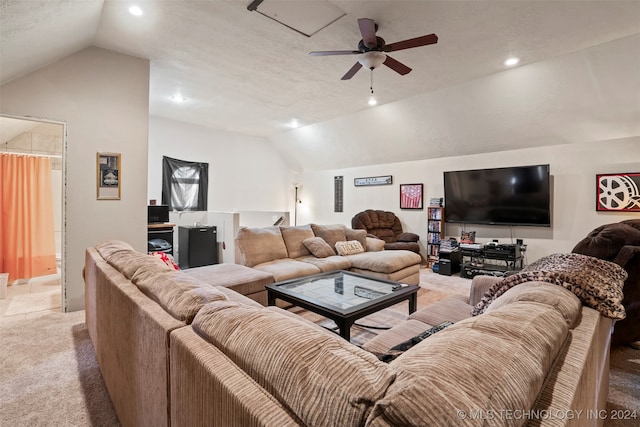 living room with light carpet, a textured ceiling, vaulted ceiling, and ceiling fan