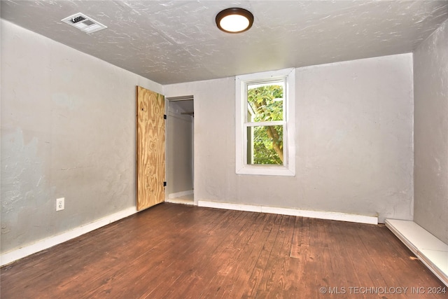 spare room featuring dark hardwood / wood-style floors