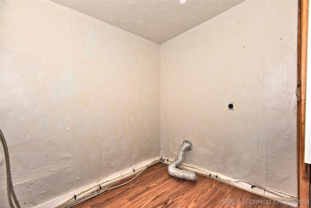 laundry room with electric dryer hookup and hardwood / wood-style floors