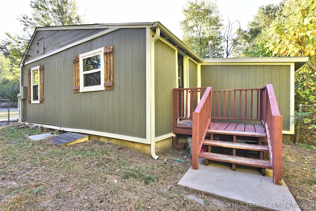 view of side of home featuring a wooden deck