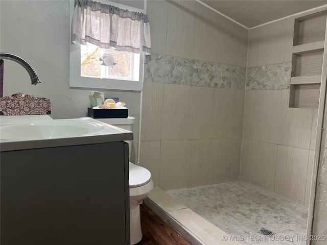 bathroom featuring walk in shower, vanity, and toilet