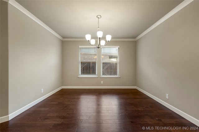 empty room featuring crown molding, a notable chandelier, and dark hardwood / wood-style floors