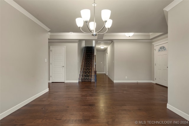 interior space featuring ornamental molding, a notable chandelier, and dark hardwood / wood-style floors