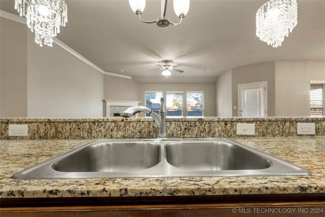 15410 E 87th St, Owasso, OK 74055 - detailed view of a chandelier, a sink, ceiling fan, and light stone countertops