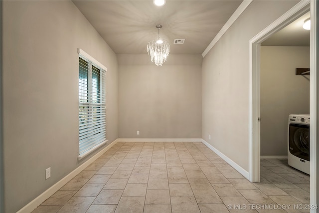 unfurnished room with crown molding, an inviting chandelier, and washer / clothes dryer