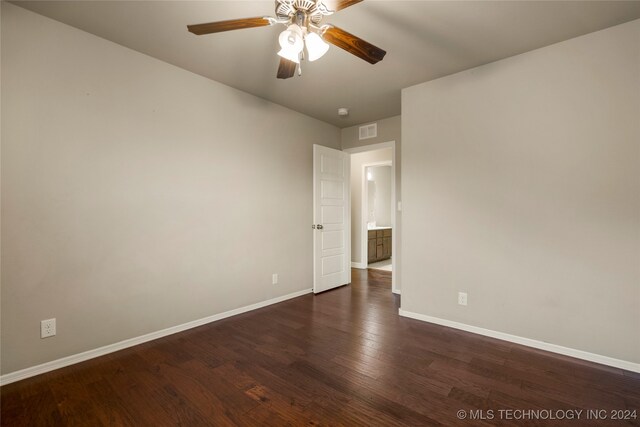 spare room featuring ceiling fan and dark hardwood / wood-style flooring